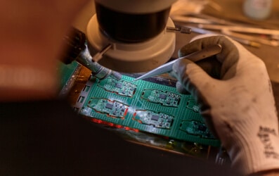 Micro technic employee working on PCB print